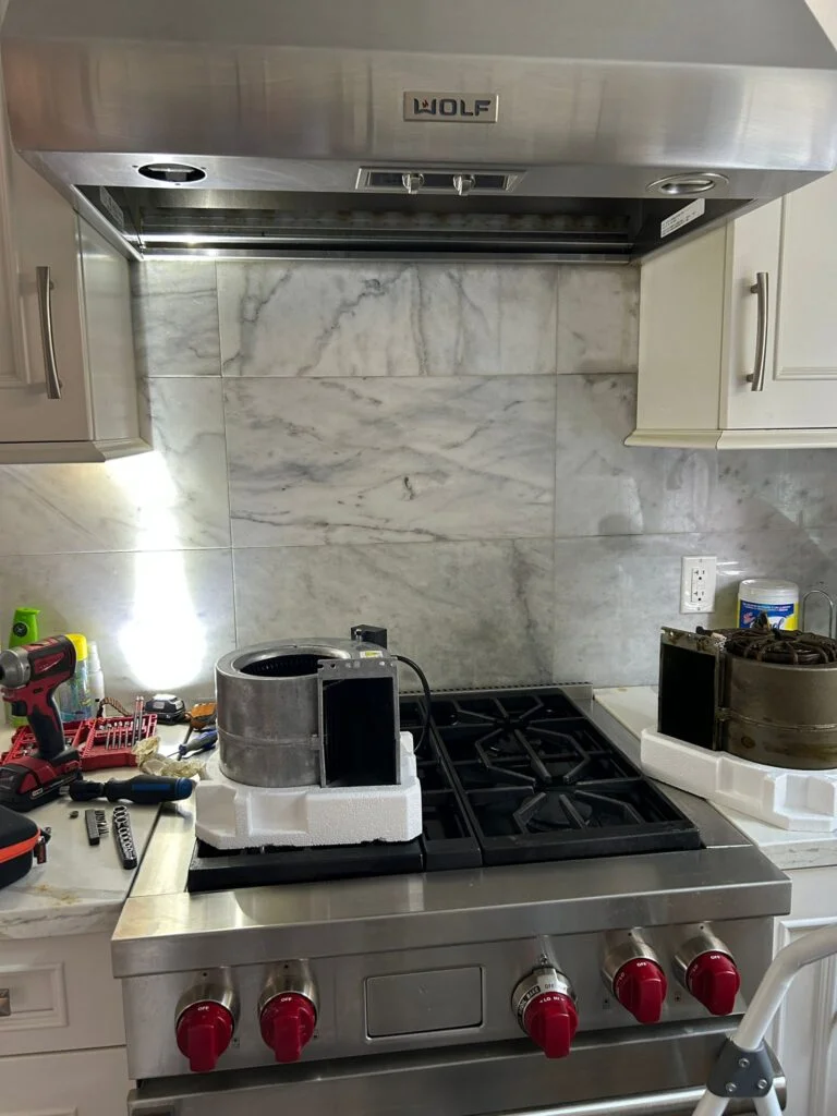 Appliance repair technician inspecting dryer components in New York City